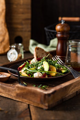 Fresh arugula salad with mozzarella, avocado, beetroot, walnuts and oranges. Espresso and orange juice dressing. Served on wooden tray. 