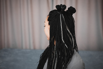 Portrait of a beautiful cool girl with Senegalese pigtails twists very cool