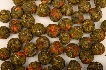 A ball of flower tea on a white background. Close up.