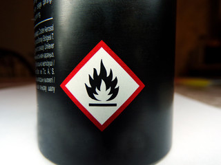 Flammable emblem on the balloon close-up. Icon warning of flammable liquids. Warning sign. Red diamond-shaped sign.
