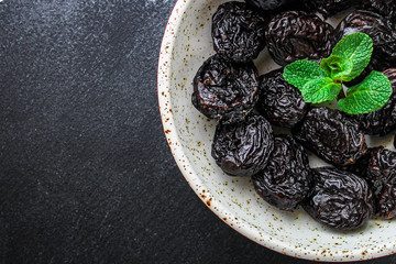 prunes, dried plums (tasty and healthy fruits) desiccated menu concept. background. top view. copy space