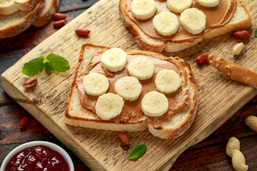 Peanut Butter and banana Sandwich on wooden board. morning breakfast