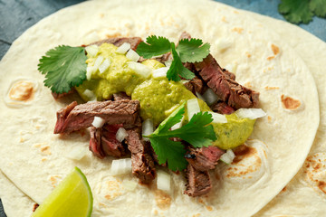 Carne Asada Tacos with grilled steak, green sauce and onion. Mexican food