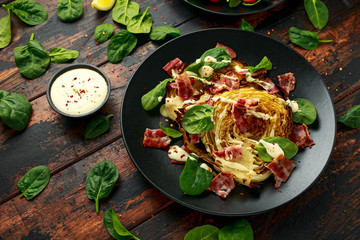 Oven roasted cabbage steaks with bacon, spinach and mayonnaise. healthy food