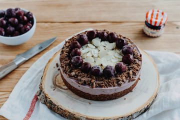  Cherry cake on a wooden background. Almonds in a raw dessert.