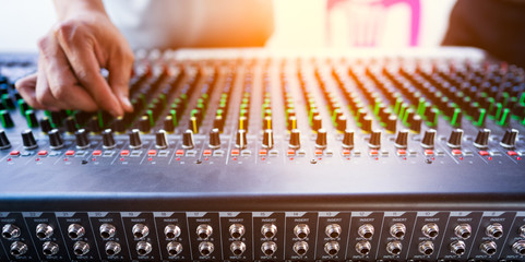 ็Music mix studio concept, hand control mixing sound console for good sound in concert,...
