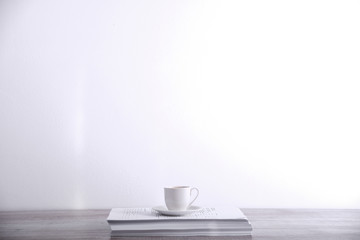 Take a break drink coffee concept. Cup of coffee on a stack of paper on the table