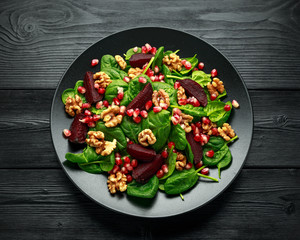 Healthy Beet Salad with fresh sweet baby spinach, pomegranate seeds and candy walnut. healthy Vegan vegetarian, plant based food