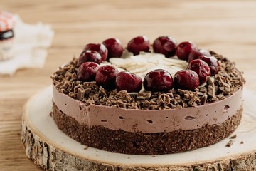  Cherry cake on a wooden background. Almonds in a raw dessert.