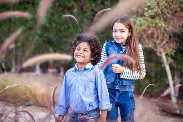 Two happy kids boy and girl playing outdoor. Childhood and emotions concept.