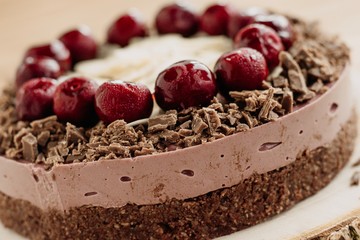  Cherry cake on a wooden background. Almonds in a raw dessert.