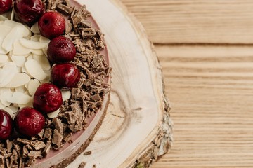  Cherry cake on a wooden background. Almonds in a raw dessert.