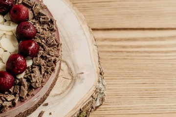  Cherry cake on a wooden background. Almonds in a raw dessert.