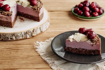  Cherry cake on a wooden background. Almonds in a raw dessert.