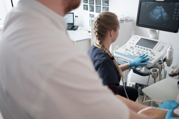 Dog having ultrasound scan in vet office.