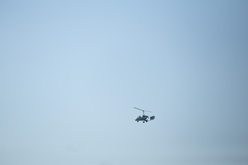 Flying helicopter in the blue sky