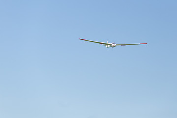 Flying glider in the blue sky