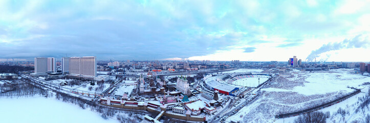 panorama of the city and the park in winter and sunrise shot from a quadrocopter