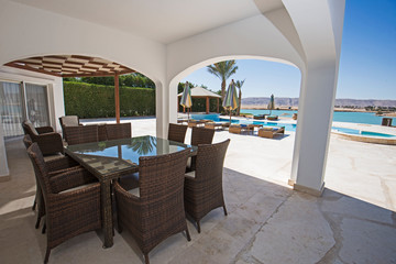 Swimming pool and outdoor seating area at a luxury tropical holiday villa