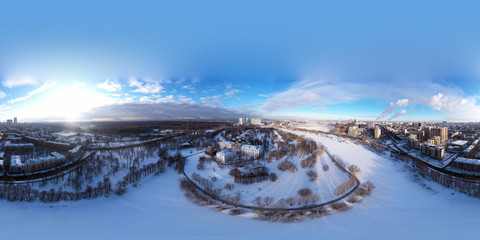 panorama of the city and the park in winter and sunrise shot from a quadrocopter