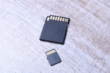 Micro SD memory card adapter on the wooden background table. close up