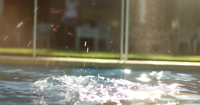 Woman going underwater at swimming pool. Girl submerging at the pool