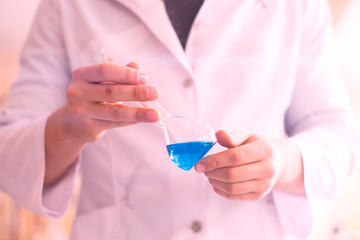 the medic person doctor in the hospital laboratory hold glass flask with medicine reagent