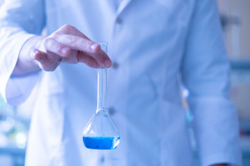 the medic person doctor in the hospital laboratory hold glass flask with medicine reagent