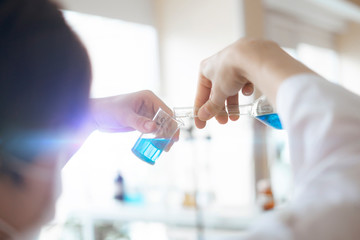 the medic person doctor in the hospital laboratory hold glass flask with medicine reagent