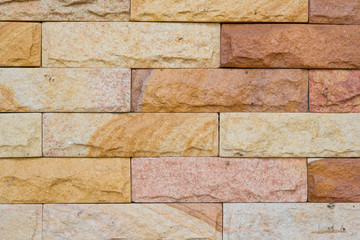 stone wall in orange brown tone with rectangular block