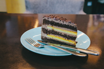 delicious puff of orange-chocolate piece of cake served on a turquoise plate. Homemade Chocolate Cake with Orange and Chocolate Chips. fresh baked slice of tasty pie