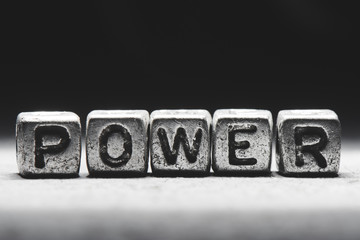 Power concept. 3d inscription on metal cubes on a gray black background isolated