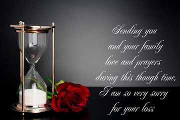 our deepest condolences sand  timer clock  on black background with text