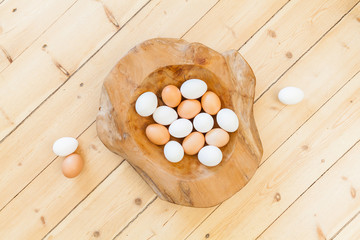 easter background decoration with eggs in wooden bowl on wooden floor. Spring decoration. Naturally designing sustainable healthy easter healthy life