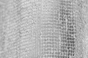 Selective focus on wave shaped fabric close up in monochrome