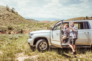 Father and son out in nature, having fun and camping in truck. Bridger, Montana, USA