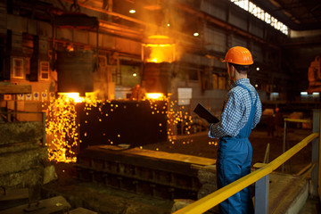 Master steelmaker at furnace, steel factory