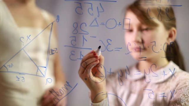 development of intelligence. child psychology. home schooling. Homework. A woman teaching a child. School, development. The girl writes on the Board