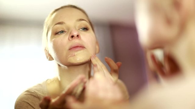 girl looks in the mirror, not pleased with the appearance, pulls the skin. Ugly, aging skin. Allergic to cosmetics, fear of aging, under eye circles, wrinkles. Low self-esteem, dysmorphic disorder. 