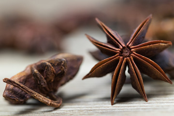 star anise with or without seed, closed, on a light wooden surface. spice for the recipe. beautiful picture, background.