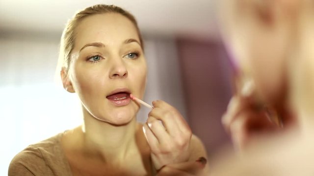 girl looks in the mirror, not pleased with the appearance, pulls the skin. Ugly, aging skin. Allergic to cosmetics, fear of aging, under eye circles, wrinkles. Low self-esteem, dysmorphic disorder. 