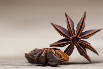 star anise with or without seed, closed, on a light wooden surface. spice for the recipe. beautiful picture, background.