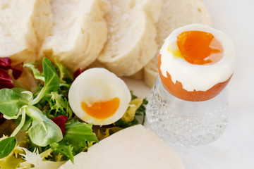 Sandwich with hard-boiled egg and vegetable salad.