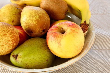 Naklejka na ściany i meble Bowl with various fruits - pears, apples, bananas.