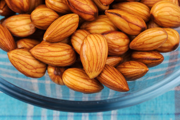 Closeup fresh almonds in bowl on table background, Fresh almonds material for almonds milk.