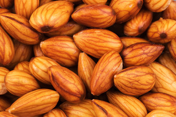 Closeup fresh almonds in bowl on table background, Fresh almonds material for almonds milk.