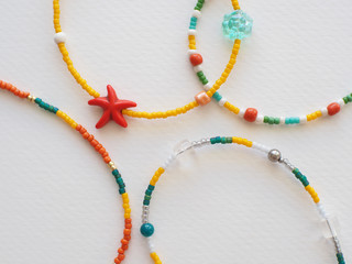 Bracelet and Necklace : Mixed beads with various materials  isolated on white  paper