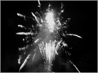 Extra firework diffusion by night with  simply black and white colors display close-up. Explosion in sky by dark night