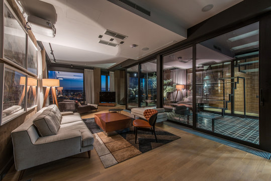 Interior of a living room in a luxury penthouse apartment in the evening