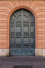 Fototapeta na wymiar ancient wooden arched grey door, Italy Europe 